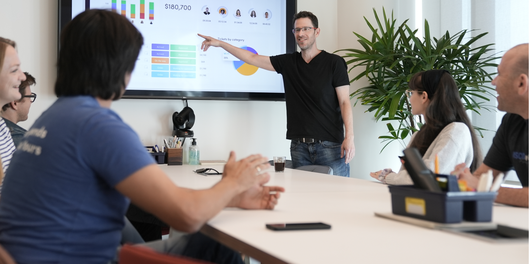Business professionals attentively watching a presentation on a screen in an office setting